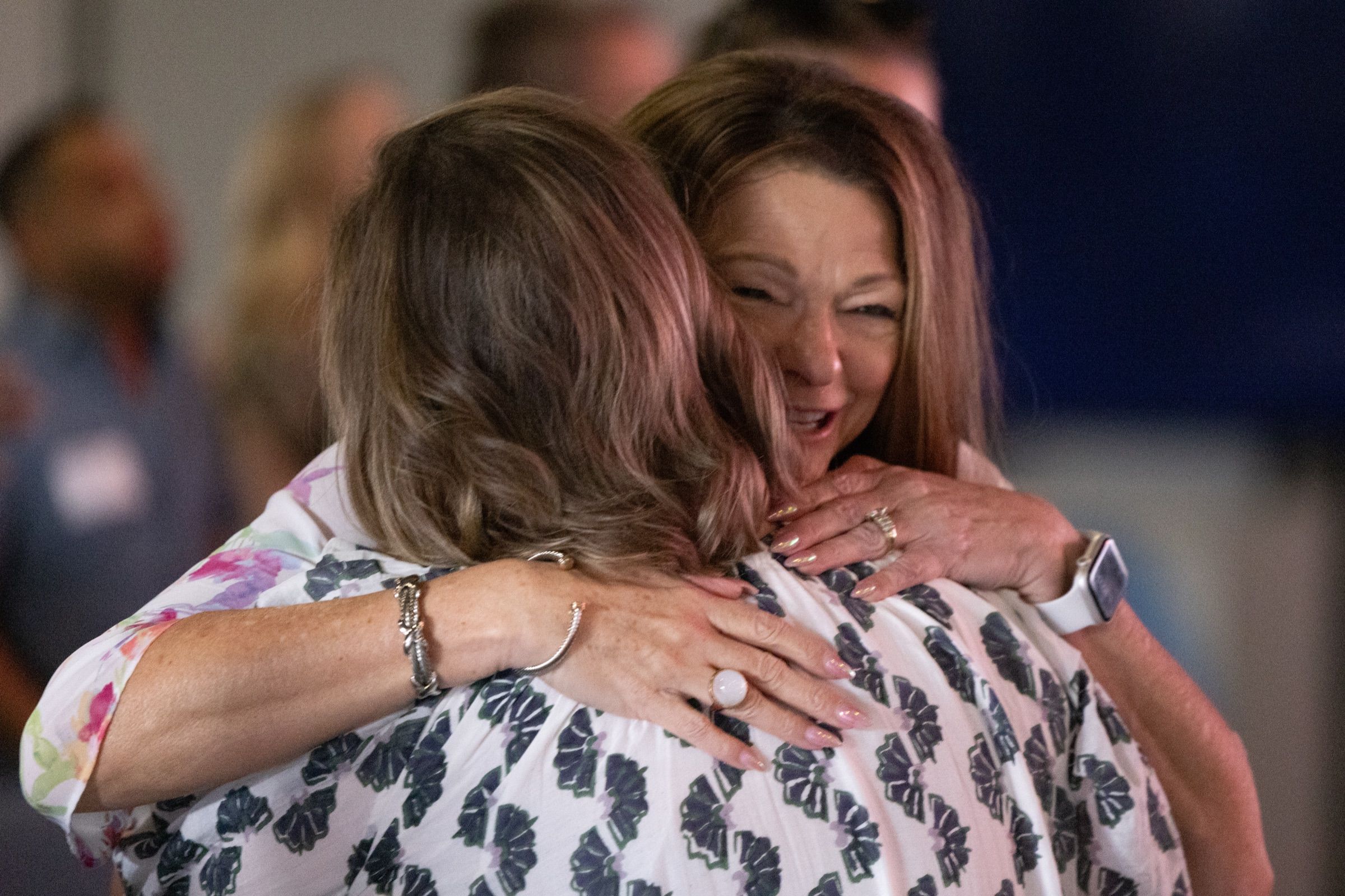 Two women embracing during a service