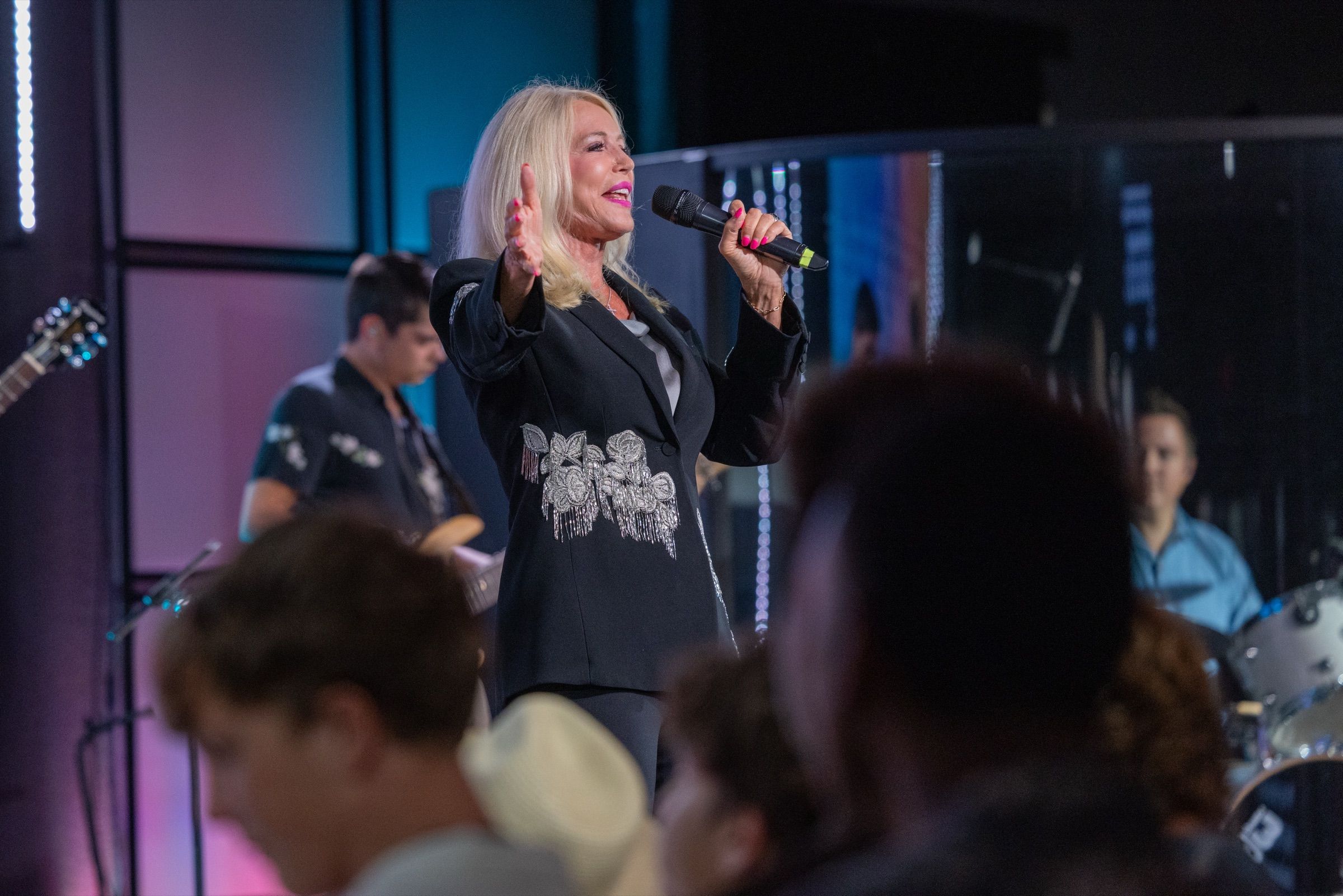 Dr Bev Wolmarans ministering with a microphone