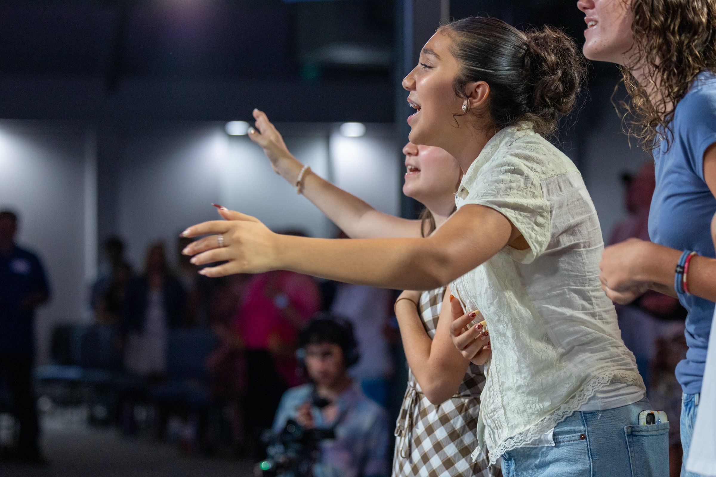 Young people worshipping with open hands